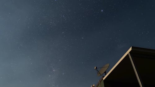 Starry sky, Milky Way Galaxy time-lapse at night, clear sky full of stars, antenna in the foreground