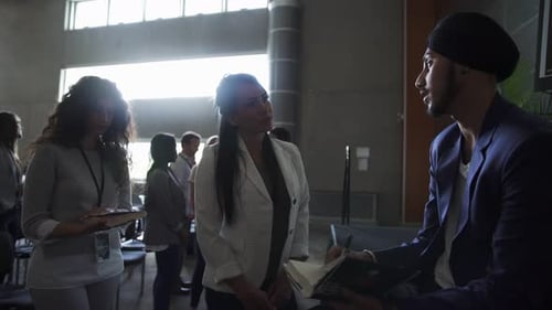 People talking at a conference in a meeting room