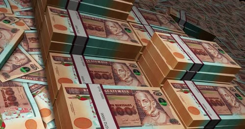 Guatemala quetzal banknote packs flying over money stacks