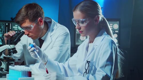 Medical Scientists Working in Lab Doctor Teaching Intern to Make Blood Analyzing Research Laboratory