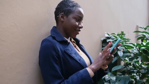 Young Woman Using Smartphone in Urban Environment