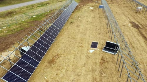 Newly constructed developing solar farm with bare metal lattice frames, aerial