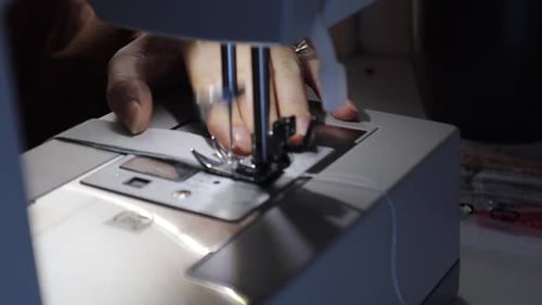 Adult Sewing Fabric Using Sewing Machine Close Up