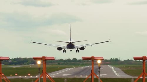 Commercial Jet Aircraft Landing on Soaked Runway During Overcast Weather with Unstable Crosswinds