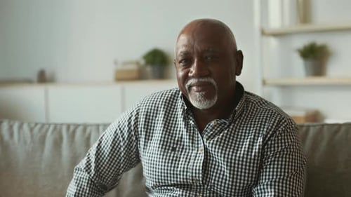Elderly African American Man Sitting Comfortably at Home in a Relaxed Setting