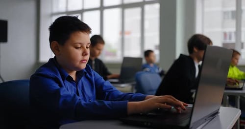 Exam In Coding Classes Portrait Of Concentrated School Students Working With Laptops In Classroom