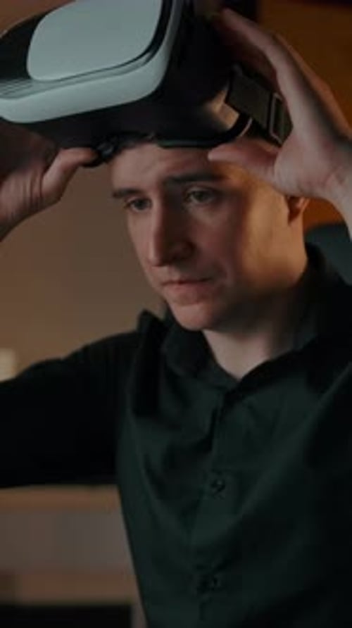 Vertical of Engineer in Cozy Interior Working with Laptop in VR Helmet