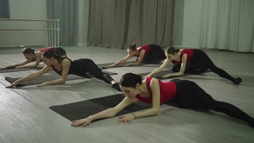 Group Stretching Class with a Trainer in a Large Hall