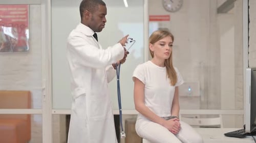 Doctor Examines Patient with Stethoscope in Clinic
