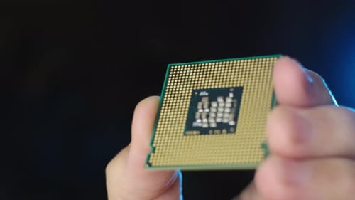 Close up view CPU processor hold by technician, Rack focus black background