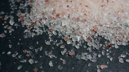 White Salt Closeup Macro Spice for Food Sea Salt for Bath Man Hand Srewing Salt on Table
