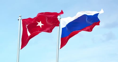 Turkey and Russia Flags Waving on Flagpoles