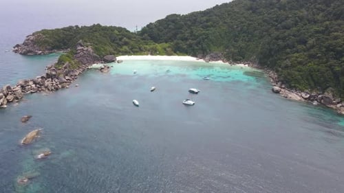 Time lapse Similan beach and far back from island show sailing of boat and mountain in island