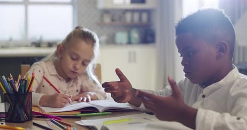 4k video footage of a group of young friends doing their homework together at the kitchen table