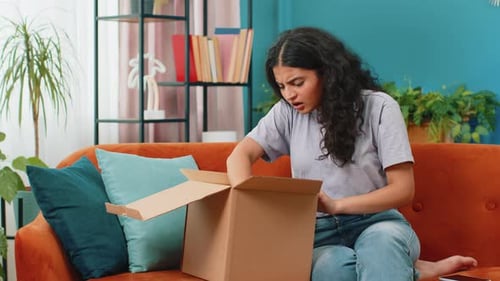 Woman Opens Box With a Surprised Expression