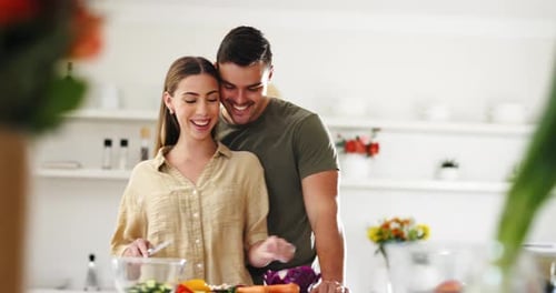 Loving Couple Cooking Healthy Meal Together in Kitchen