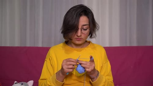 Young Woman Knitting at Home at Night Close Up 4K