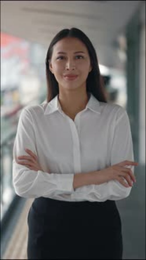 Vertical Video Attractive Teacher Standing Indoors and Crossing Her Hands Wearing White Shirt and