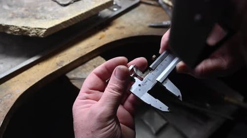 Jeweler Measuring a Ring with a Caliper