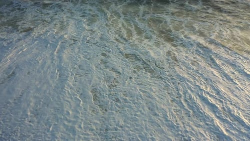 Ocean Waves Rolling Onto Sandy Beach