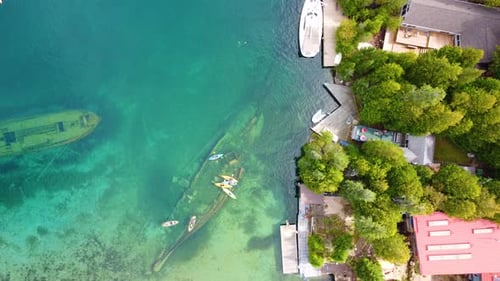 Wrecks or shipwrecks under the surface of the water next to the seashore. Aerial drone overhead shot