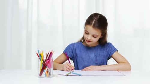 Girl Drawing with Colored Pencils at White Table