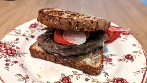 Delicious sandwich or burger on a table, close-up of freshly made lunch with bread, lettuce, tomato,