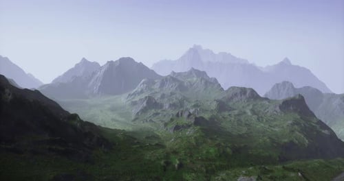 Vast Mountain Range Under Clear Sky with Green Valleys in Daylight