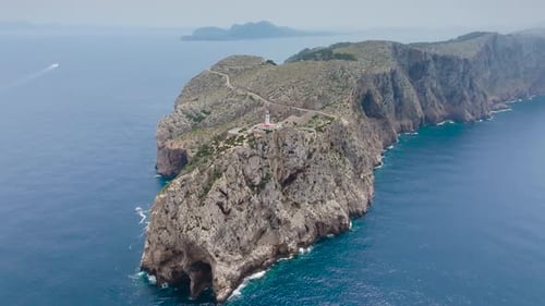 Rugged limestone cliff with lighthouse