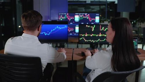 Business Team Trading Stocks Stock Traders Looking at Graphs Indexes and Numbers on Multiple