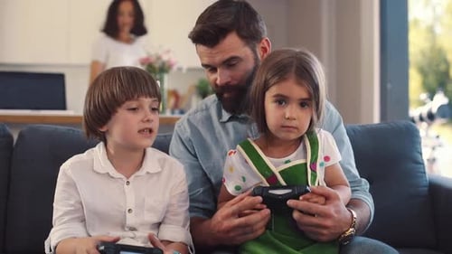 Family Together on Couch Plays Video Games