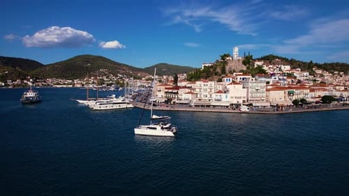 Drone View Of Yacht On Greece Sea with city and mountains in the background