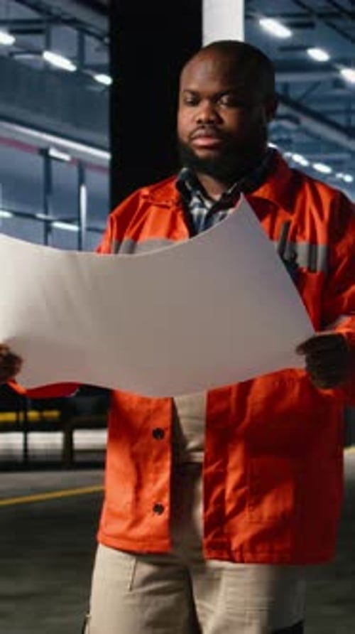 Vertical Video Black Supervisor Checking Industrial Plans for Coordinating Operation Tasks