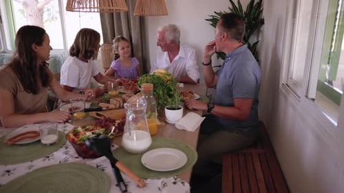 Family of Five Sharing Cheerful Meal Inside