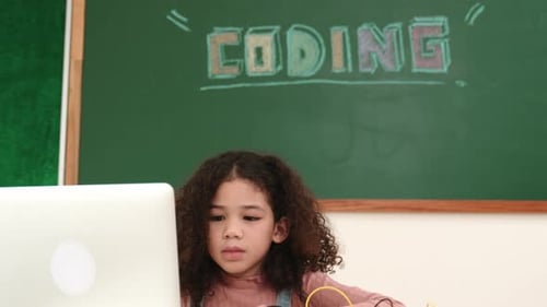 Attractive african student programing system while looking at camera. Pedagogy.
