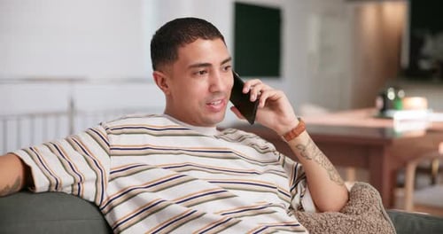 Young Adult Talking on Cell Phone on Couch