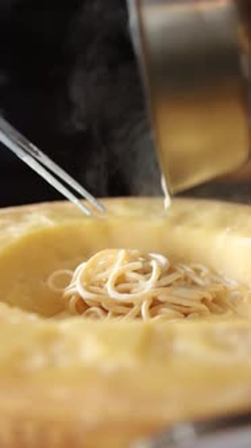 Preparing Creamy Pasta Inside a Cheese Wheel