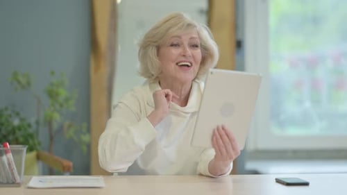 Smiling Woman Video Chats Using Tablet