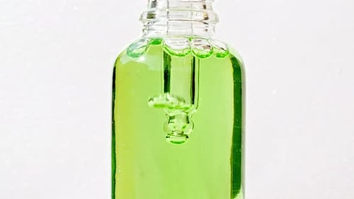 Green Liquid in Glass Bottle with Bubbles