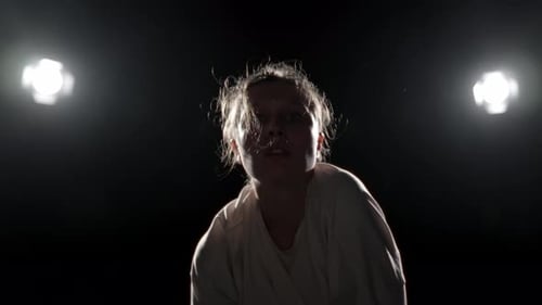 Woman Performing Dramatic Dance Solo on Stage