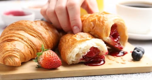 Hand Picking Delicious Berry Filled Croissant