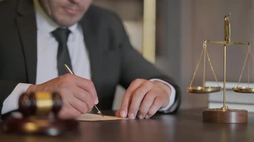 Close up of Judge Writing Documents in Office