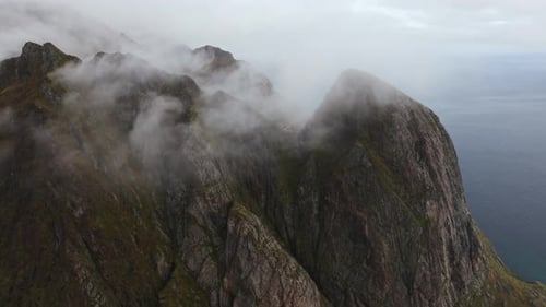 Aerial Flight Over Steep Peaks of the Lofoten Islands Norway From a Mountainside View