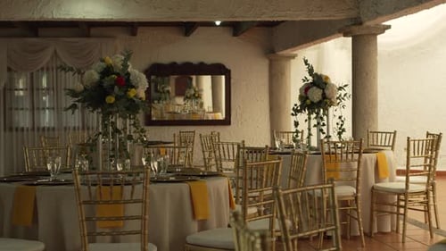 Hall with tables decorated for wedding reception with fresh flowers. Banquet table.
