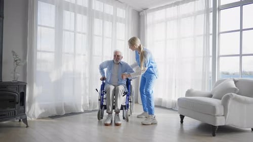 Nurse Helps Old Wheelchair Man to Walk Physical Therapist Woman Provides Medical Support to Senior