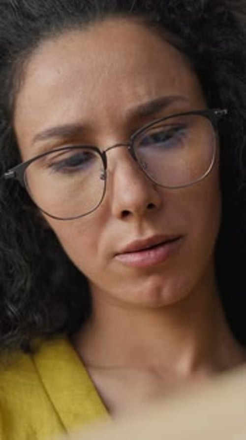 Calm Latina Hispanic Woman in Eyeglasses Reading Book in Quiet Library Female Student Girl Turning