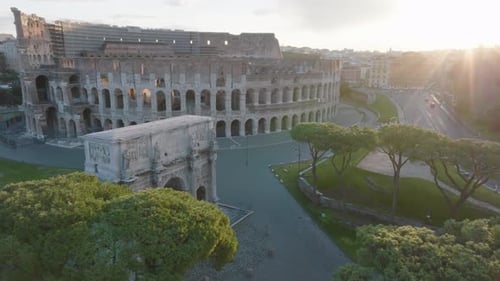 Aerial view around the sunlit Arch of Constantine, at Piazza del Colosseo, sunny morning in Rome,