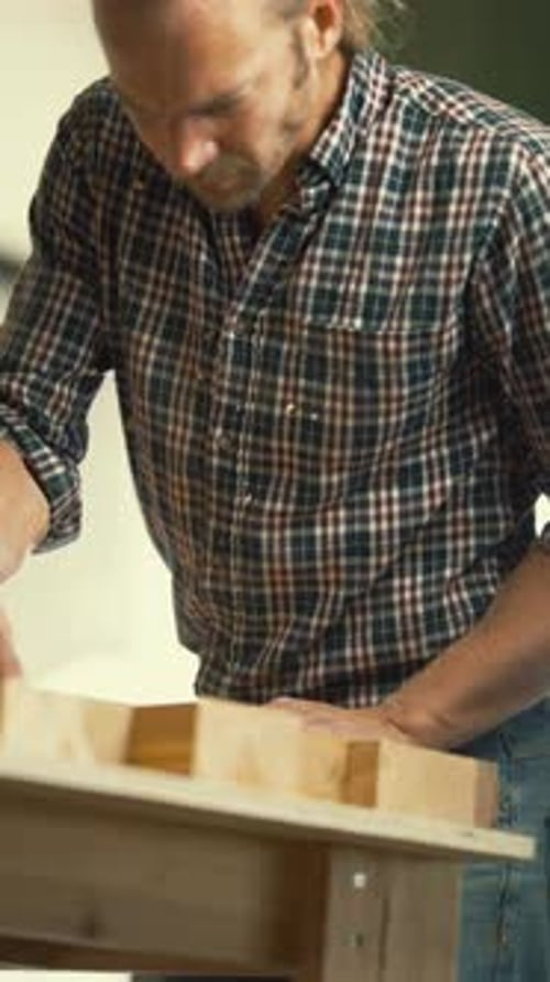 Carpenter Working on a Wood Project in His Workshop
