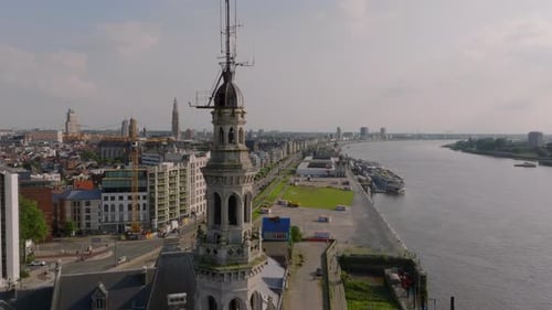 Aerial Views Capture the Antwerp's Skyline Showcasing Cars Moving Along a Road By the Scheldt River