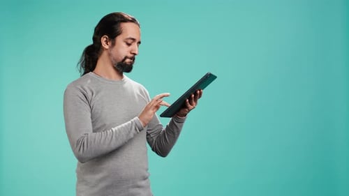 Portrait of Upbeat Person Mindlessly Scrolling on Tablet Screen